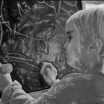 Child writing of a blackboard