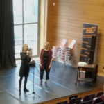 women presenting on stage